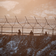 South Korean soldiers patrol along a barbed-wire fence near the demilitarized zone separating the two Koreas, in Paju, South Korea, December 21, 2017.